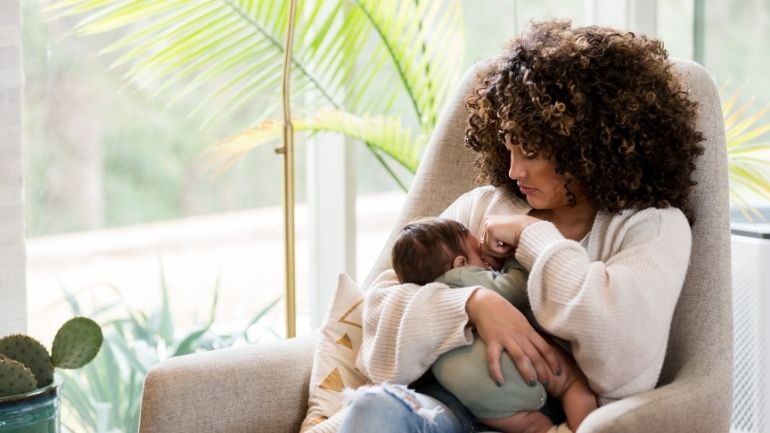 mother with newborn in a chair